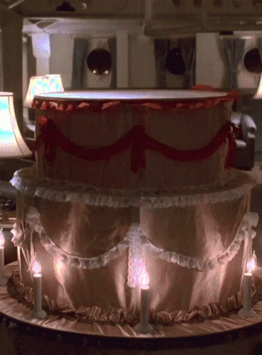 woman jumping out of cake gif