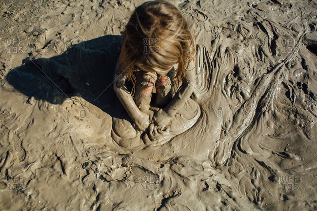 adam bogle add women playing in mud photo